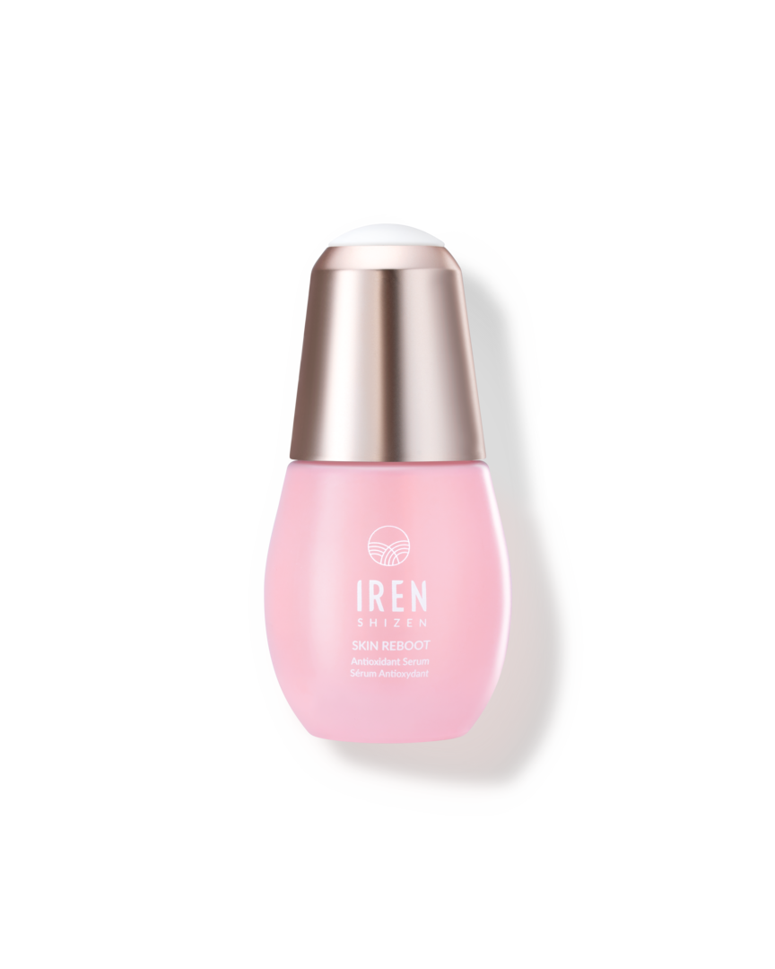 A pink SKIN REBOOT Antioxidant Serum bottle with a pink cap on a black background, by IREN Shizen, custom skincare.