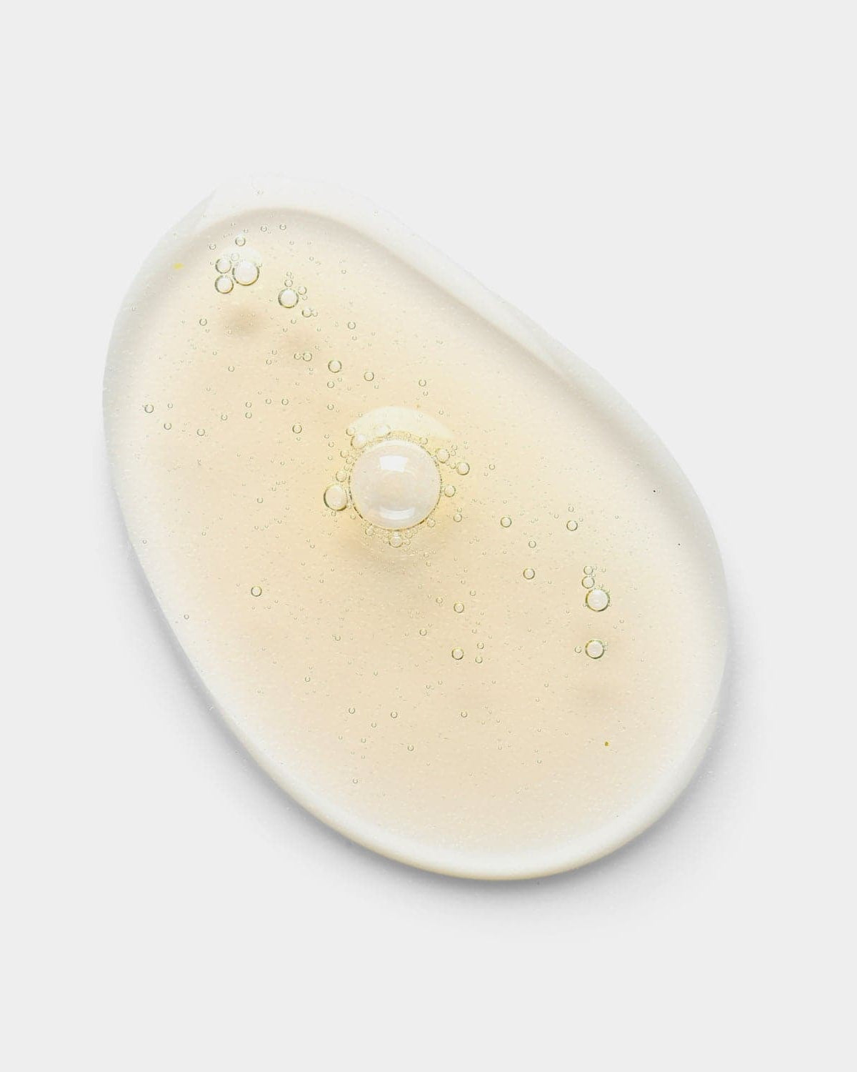 This Niacinamide serum, CLEARER DAYS Anti-Blemish Serum by IREN Shizen, features a translucent gel with small bubbles and a single pearl in the center, presented against a plain white background as an inviting solution for clear skin.