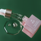 A bottle of IREN Shizen BLOOM OF YOUTH Restoring Facial Oil, customized Japanese skincare, on a green background. #all-groups